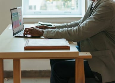 man writing on laptop