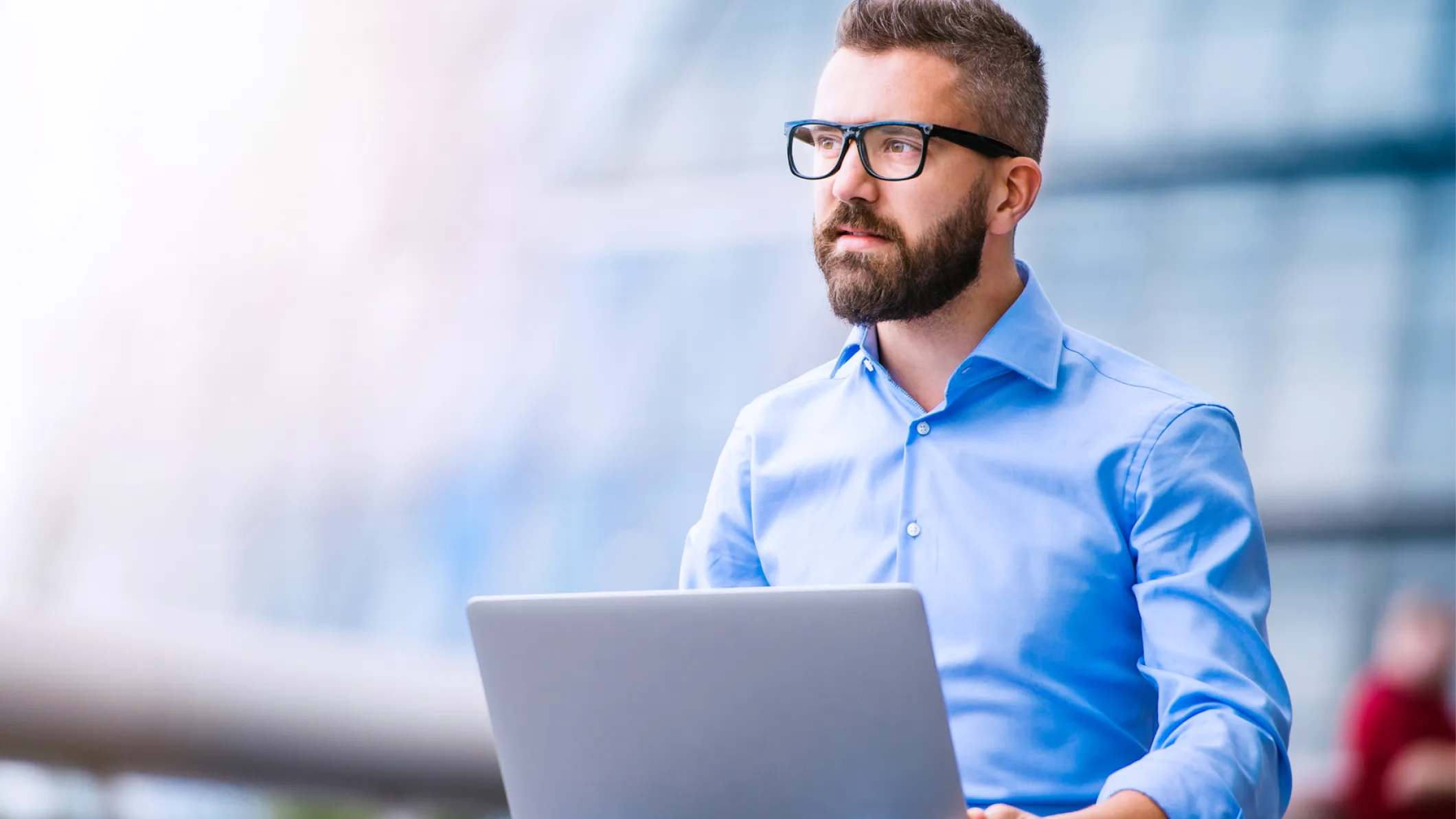 Man sitting thoughtfully with laptop