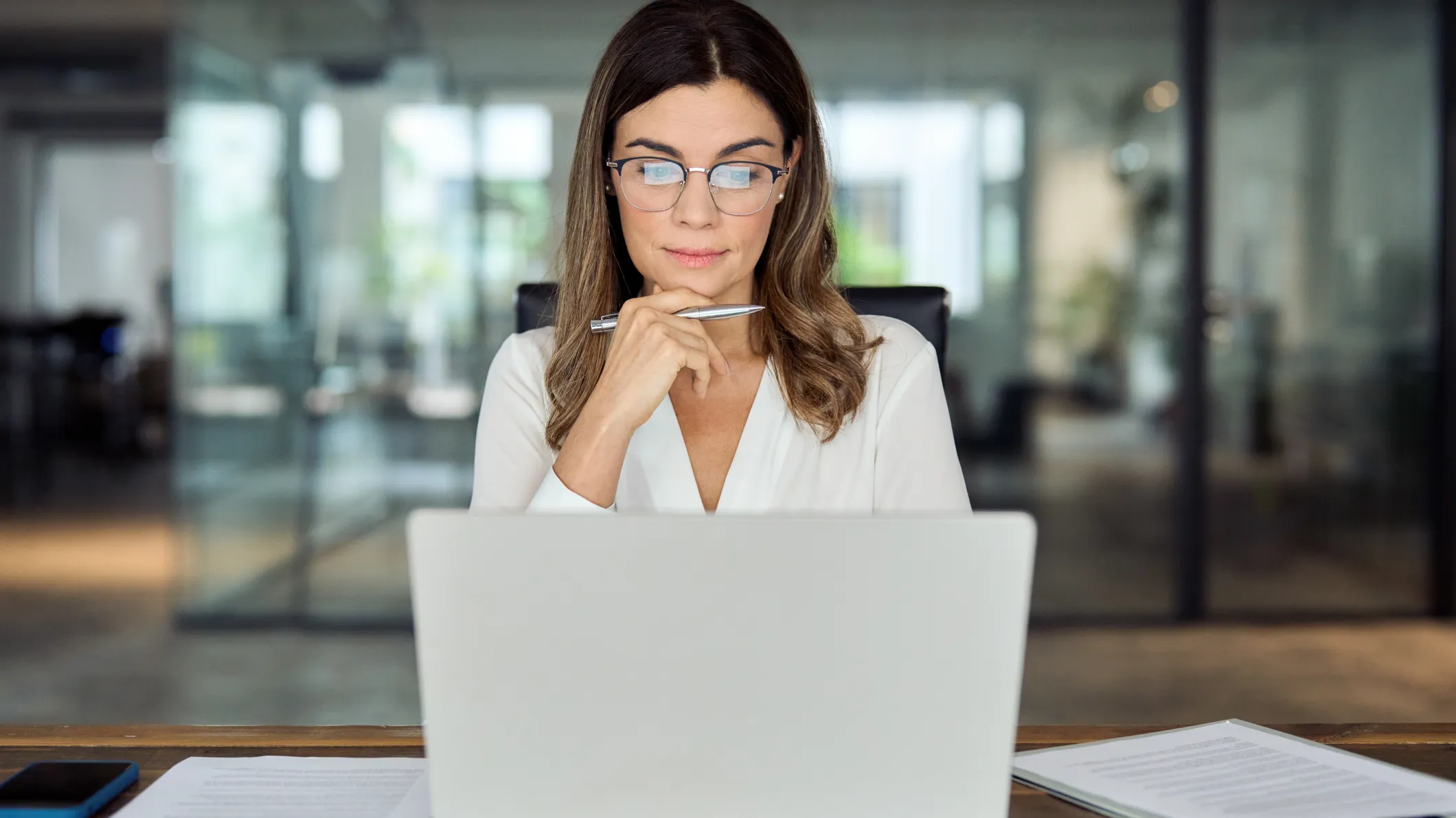 Professional woman looking at a laptop