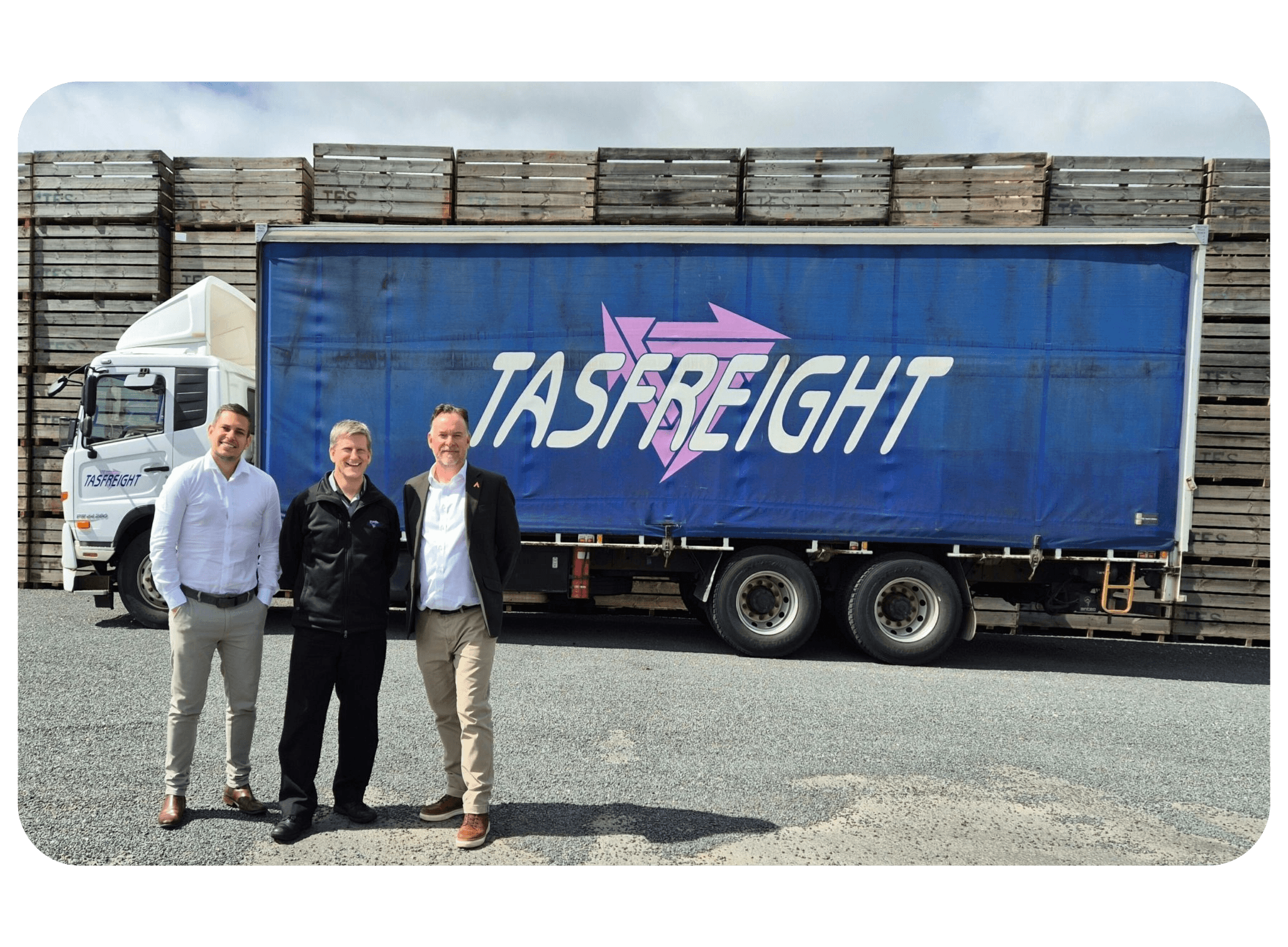 3 men standing infront of a truck
