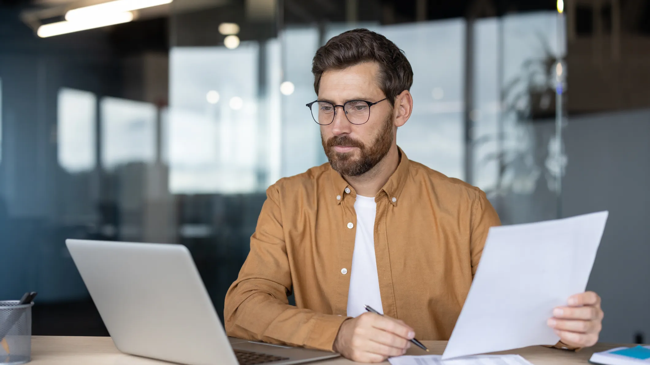 Man wearing glasses processing data