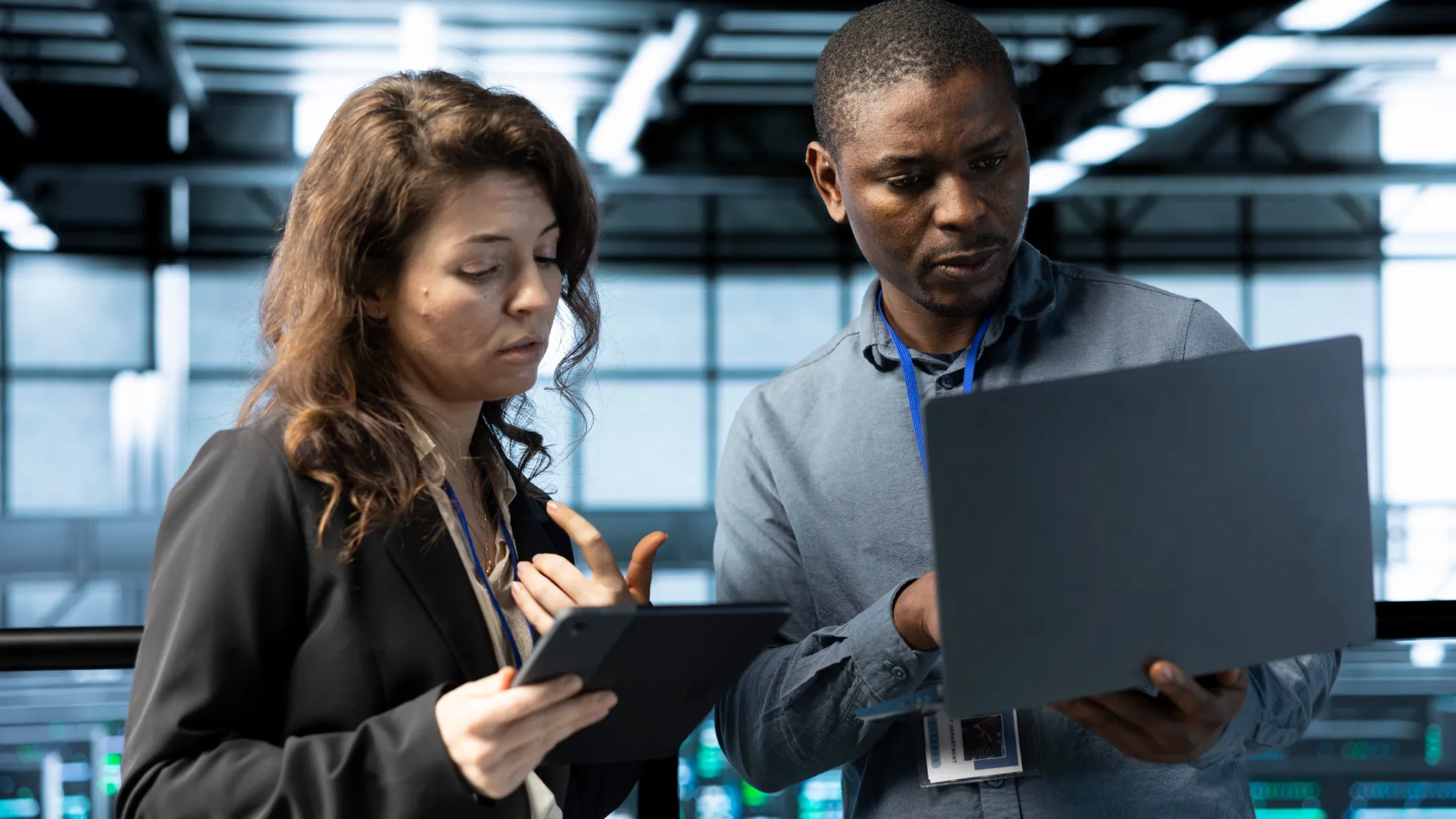 Programmers in data center using laptop and tablet