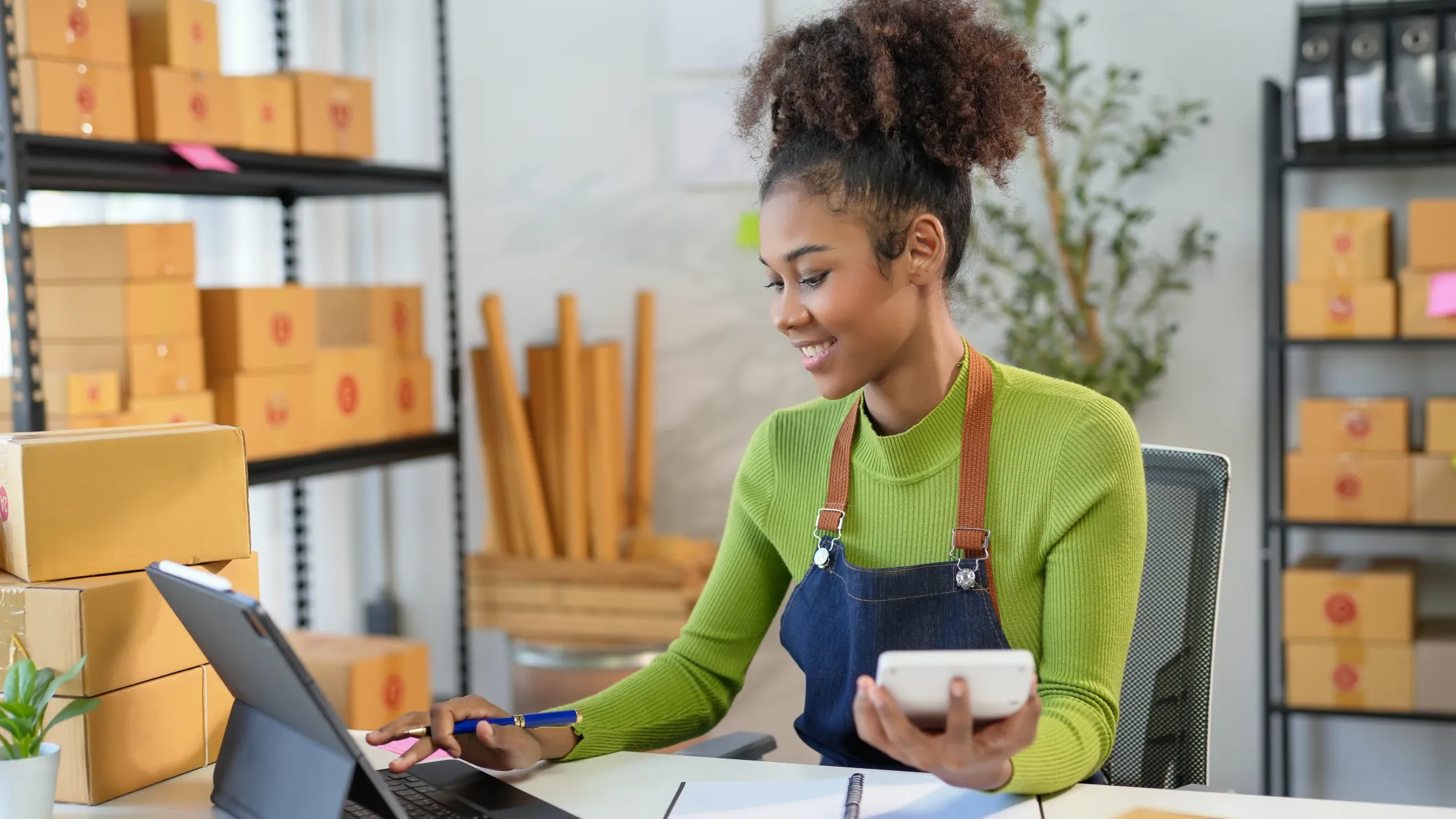 Smiling retail owner manages her accounting