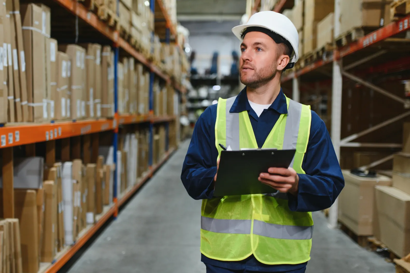 Warehouse worker making use of wholesale and distribution ERP software