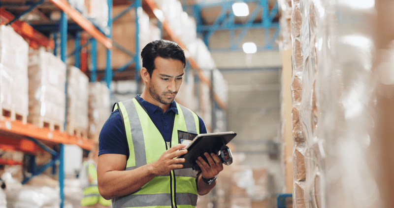 Man, boxes and scanner with tablet in logistics, e commerce or inventory of order or courier solution. Serious industrial worker with digital software for price check, information or package schedule