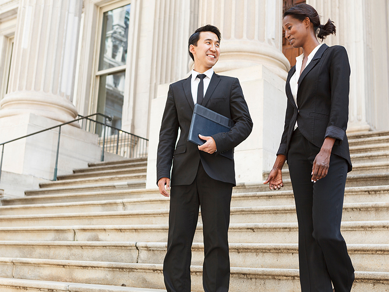 Colleagues having conversation on steps to building