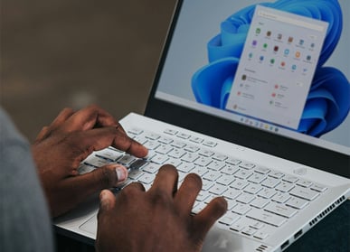 close up of hands navigating laptop
